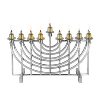 The Ricci Nickel Suspension Menorah features nine lit oil candles, including the central shamash, and stands tall in accordance with Jewish tradition against a plain white background.