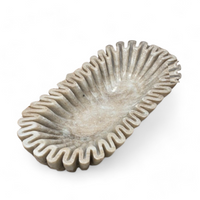 The Sagebrook Home Rift Tan Marble Oval Bowl features a ruffled edge and shallow basin, adding elegance to your decor. Its stone-like design resembles marble and is shown here on a white background.