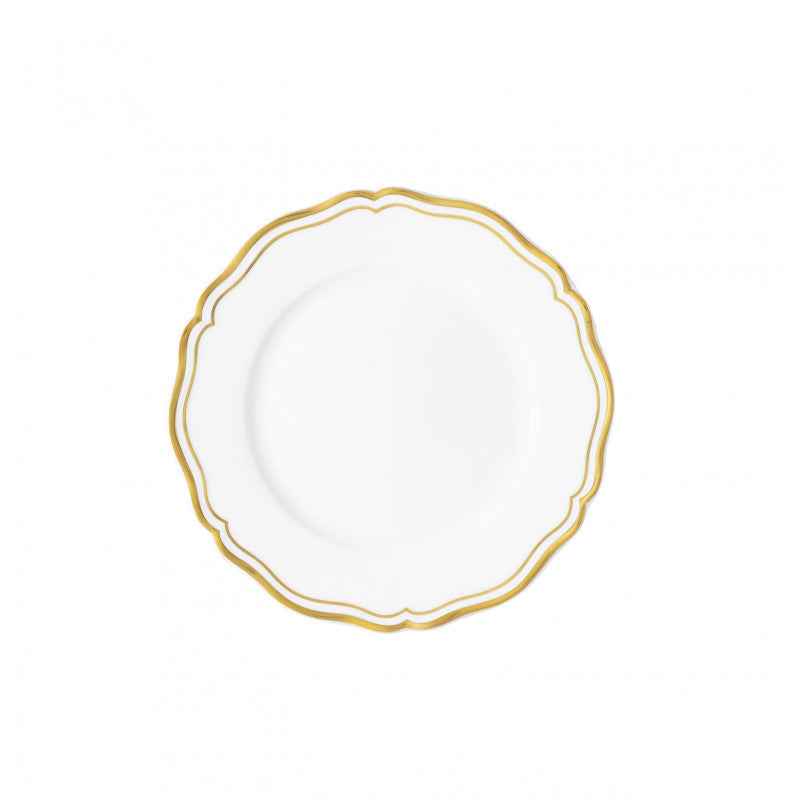 The Raynaud Polka Gold Dinnerware features a white porcelain plate with a scalloped edge and decorative gold trim on the rim, creating an elegant look on a simple white background.