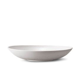 A smooth, round, shallow white ceramic bowl from L'Objet's Terra Stone Dinnerware collection, shown in profile on a white background.
