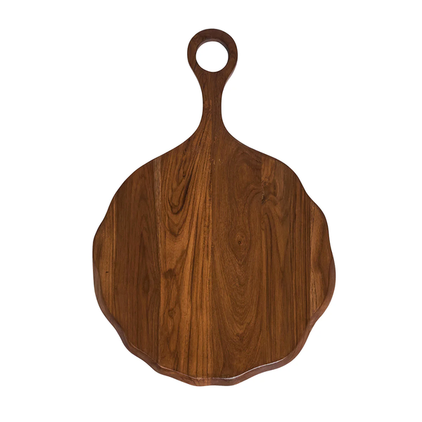 The Juliska Puro Round Serving Board Teak features hand-carved teak wood with a scalloped edge and a handle adorned with a circular hole; this elegant charcuterie board is beautifully showcased on a white background.