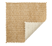 A square swatch of the Kim Seybert Vista Reversible Placemat Set of 4 in Ivory & Beige displays its textured, woven pattern and thickness, with a folded corner revealing the lighter underside and zigzag-cut edges.