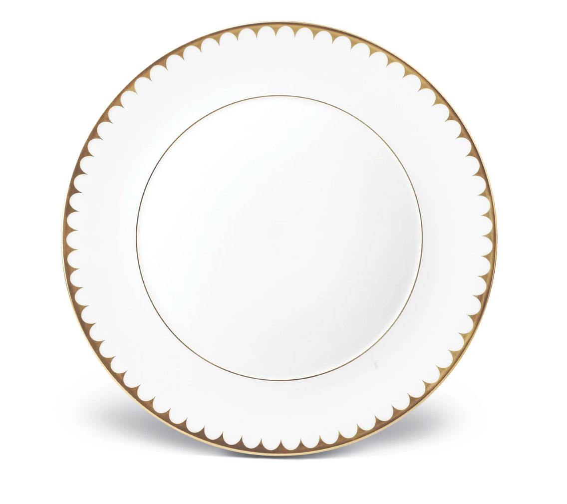 The L'Objet Aegean Filet Gold Dinnerware plate is crafted from fine white porcelain with a gold scalloped border and a thin 24k gold inner ring, set against a classic white background.