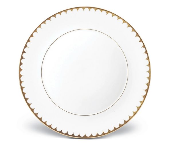 The L'Objet Aegean Filet Gold Dinnerware plate is crafted from fine white porcelain with a gold scalloped border and a thin 24k gold inner ring, set against a classic white background.