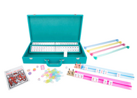 The Brouk & Co Ellen Mahjong Set - Teal features a suitcase-style vegan leather case, pastel racks, chips, dice, instructions, and player markers—an elegant and portable Mahjong set arranged on a white background.
