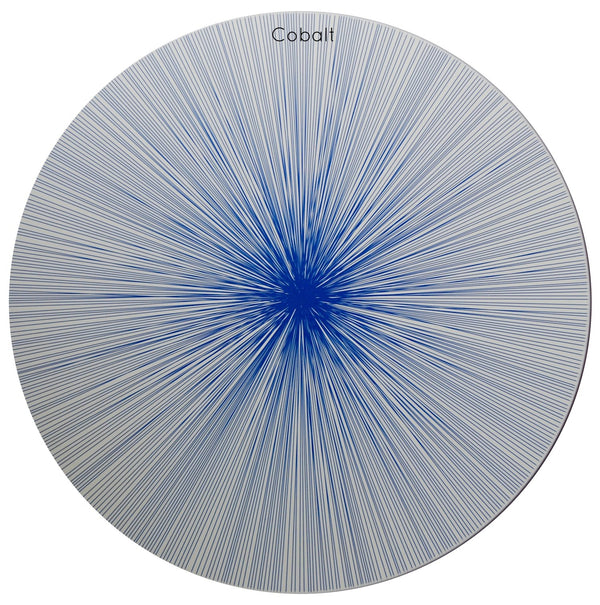 A set of four circular wooden placemats from Tisch New York, the Graphic Line Placemat set features the “Cobalt” design: bold blue lines radiate outward from the center across a white background, creating a dramatic starburst effect. Each placemat is crafted in the USA with a durable cork backing, combining artistic style with lasting functionality.