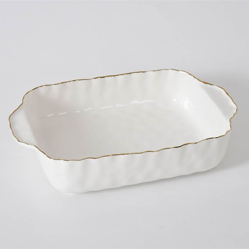 The PAMPA BAY Portofino Rectangle Baker 11 x 9 is a white porcelain baking dish with scalloped edges, gold trim, and handles on both short sides, shown on a plain light background. It is oven safe.