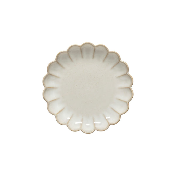 The Marrakesh Dinnerware White plate by Casafina/Costa Nova is a small, round ceramic plate with scalloped flower-like edges and a subtly speckled cream surface, reflecting Moroccan-inspired elegance. Displayed on a white background.