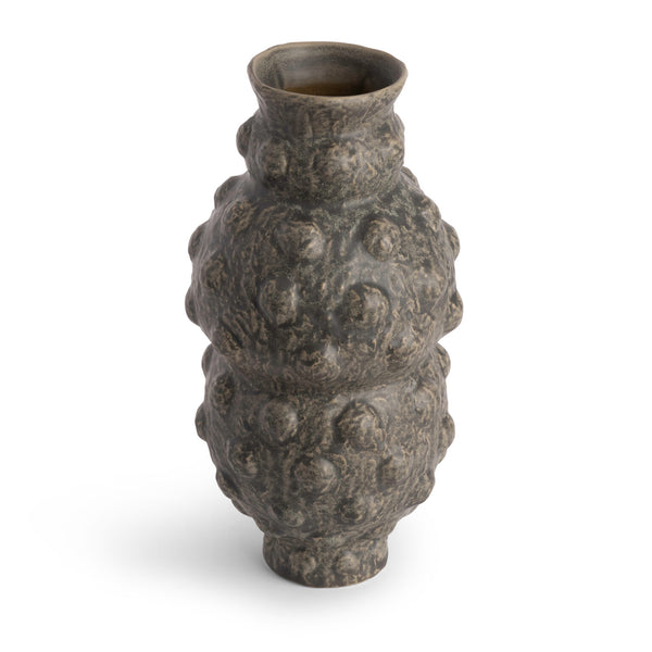 The Tobias Vase by FlowDecor Inc. is a tall, contemporary piece featuring a bumpy, irregular texture, narrow neck, and a mottled dark gray finish.