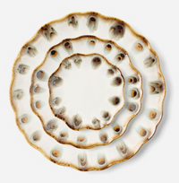Three Amoria Dinnerware scalloped edge plates by Blue Pheasant, featuring a cream base, brown edges, and brown and blue peacock-feather spots, are stacked concentrically on a white background.