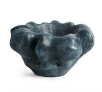 The Timna Coupe - Aged Iron by L’Objet is an organic-shaped ceramic bowl featuring a dark, textured surface with an undulating, abstract rim and wavy contours, reminiscent of porcelain and finished with a distinctive reactive glaze, showcased against a white background.