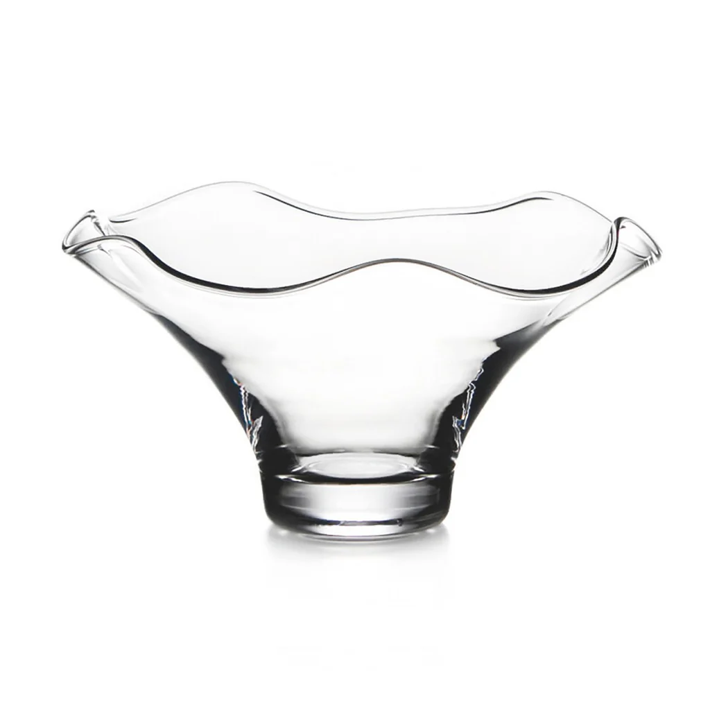 The Simon Pearce Chelsea Bowl is a clear handmade glass bowl with a wide, flared rim, wavy edge, smooth modern design, and sturdy circular base, shown against a white background.