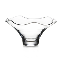 The Simon Pearce Chelsea Bowl is a clear handmade glass bowl with a wide, flared rim, wavy edge, smooth modern design, and sturdy circular base, shown against a white background.