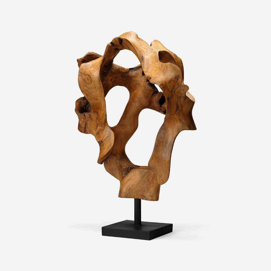 The Marcianus Sculpture Teak 20" by Made Goods features organic, abstract curves and holes, mounted on a black rectangular base—an eye-catching handmade contemporary piece set against a plain white background.