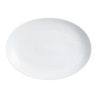 The Raynaud Mineral Dinnerware Glazed White plate features a plain, white, oval-shaped Limoges porcelain design with a subtle textured pattern, displayed on a white background.
