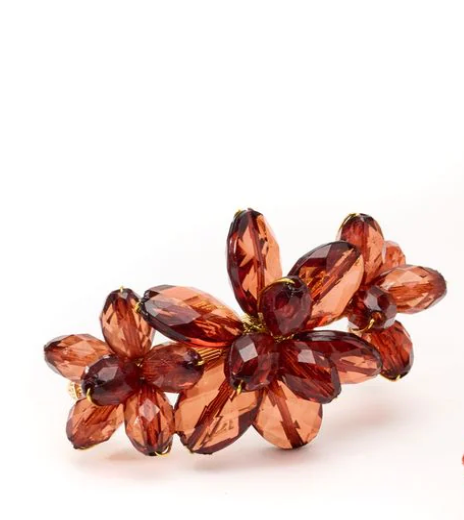The Tiara Beaded Napkin Rings Set of 4 by Deborah Rhodes features faceted amber-toned beads on a gold base, reflecting the brand's signature elegant table décor style against a crisp white background.