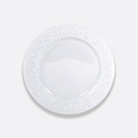 The Bernardaud Louvre Dinnerware ceramic plate features a glossy finish and a decorative swirl pattern around the rim, shown from above on a light gray background.