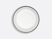 The Bernardaud Athena Platinum Dinnerware plate is round and white porcelain, featuring black vertical lines and small square designs along the rim on a light gray background.