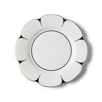 The Molecot Drops Dinnerware plate features a flower shape with a scalloped edge, delicate black lines, and a gold rim, elegantly displayed against a simple white background.