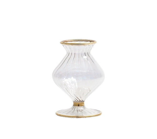 The Kim Seybert Scallop Bud Vase - Clear is a mouth-blown glass vase featuring a fluted, bulbous silhouette and a wide opening, accented with elegant 18K gold detailing on the rim, base, and middle. Inspired by the classic Scallop Bud Vase design, it is finished with a flat, round base for enhanced stability.