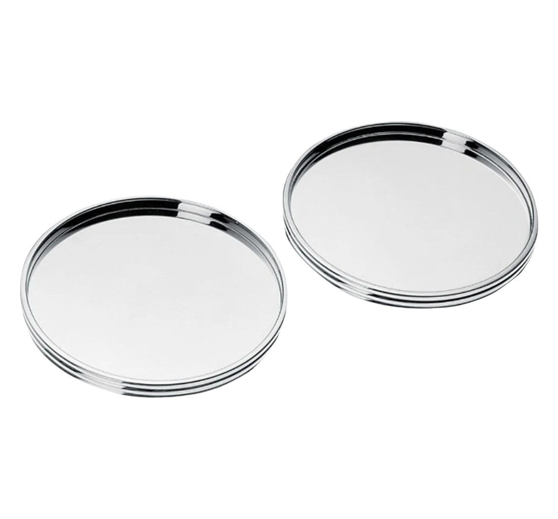 The Christofle K+T Two Silver-Plated Coasters, inspired by Adam D. Tihany, have a shiny, round design with raised edges and are displayed side by side on a plain white background.