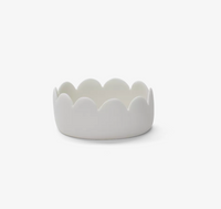 A small, white ceramic Tina Frey Fleur Oval Bowl, featuring a smooth, scalloped edge, set against a plain white background.