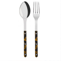 The Sabre Bistrot Shiny Solid Serving Set features a metal spoon and fork with dark handles in a yellow and brown tortoiseshell pattern, accented by three rivets, exuding Parisian flair against a white background.