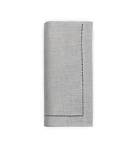 A set of four light gray Sferra Festival Napkins, each neatly folded with subtle texture and decorative stitched borders on two sides, displayed on a white background.