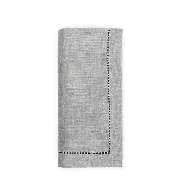 A set of four light gray Sferra Festival Napkins, each neatly folded with subtle texture and decorative stitched borders on two sides, displayed on a white background.