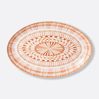 The Bernardaud Terra Rosa Dinnerware round plate features an orange and white geometric design with concentric circles and radiating lines. Made in Limoges, France.