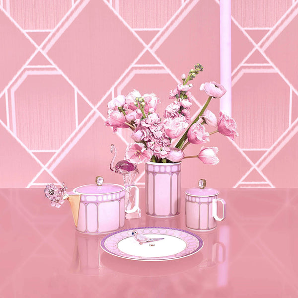 The Swarovski Signum Rose Pink Mug by Swarovski x Rosenthal features elegant floral and bird designs on a pink geometric porcelain and crystal finish. Arrives in a luxury gift box—ideal for special occasions or stylish gatherings.