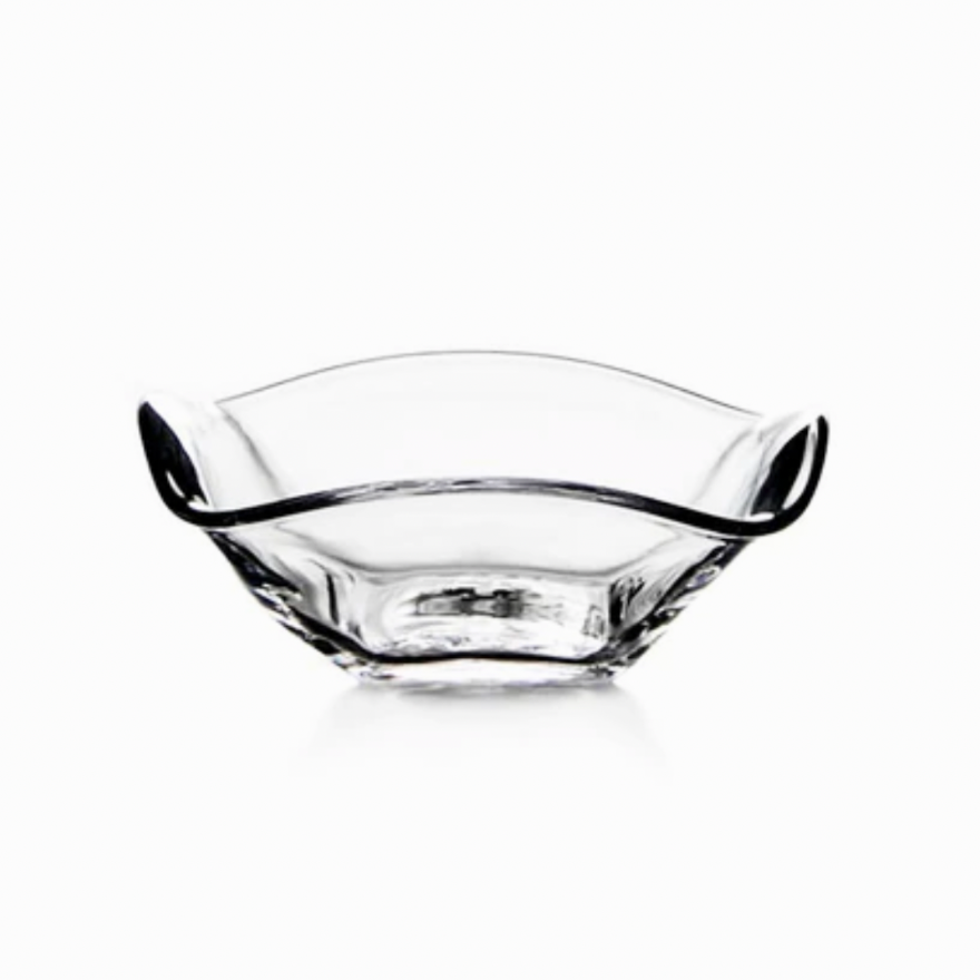 The Simon Pearce Woodbury Bowl is a clear handblown glass bowl with a wavy, asymmetrical rim and smooth edges, ideal for serving salad. Photographed on a white background.