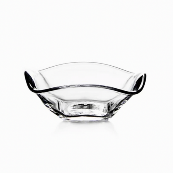 The Simon Pearce Woodbury Bowl is a clear handblown glass bowl with a wavy, asymmetrical rim and smooth edges, ideal for serving salad. Photographed on a white background.