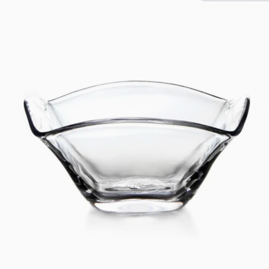 The Simon Pearce Woodbury Bowl, handblown from clear glass with a wavy, scalloped rim and square base, is displayed against a white background—ideal as an elegant salad bowl.