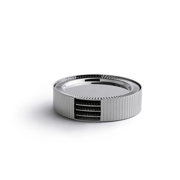 The Anna New York Striations Silver Coasters Set of 4 in Holder features round, ribbed metal coasters with exposed inner layers, resembling modern stainless steel, displayed on a white background.