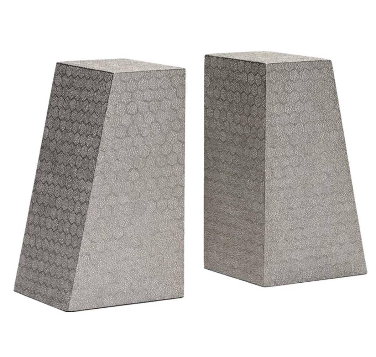 Two trapezoidal Rene Faux Shagreen Bookends by Made Goods, featuring textured geometric patterns and architectural edges, stand upright side by side against a white background.