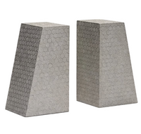 Two trapezoidal Rene Faux Shagreen Bookends by Made Goods, featuring textured geometric patterns and architectural edges, stand upright side by side against a white background.