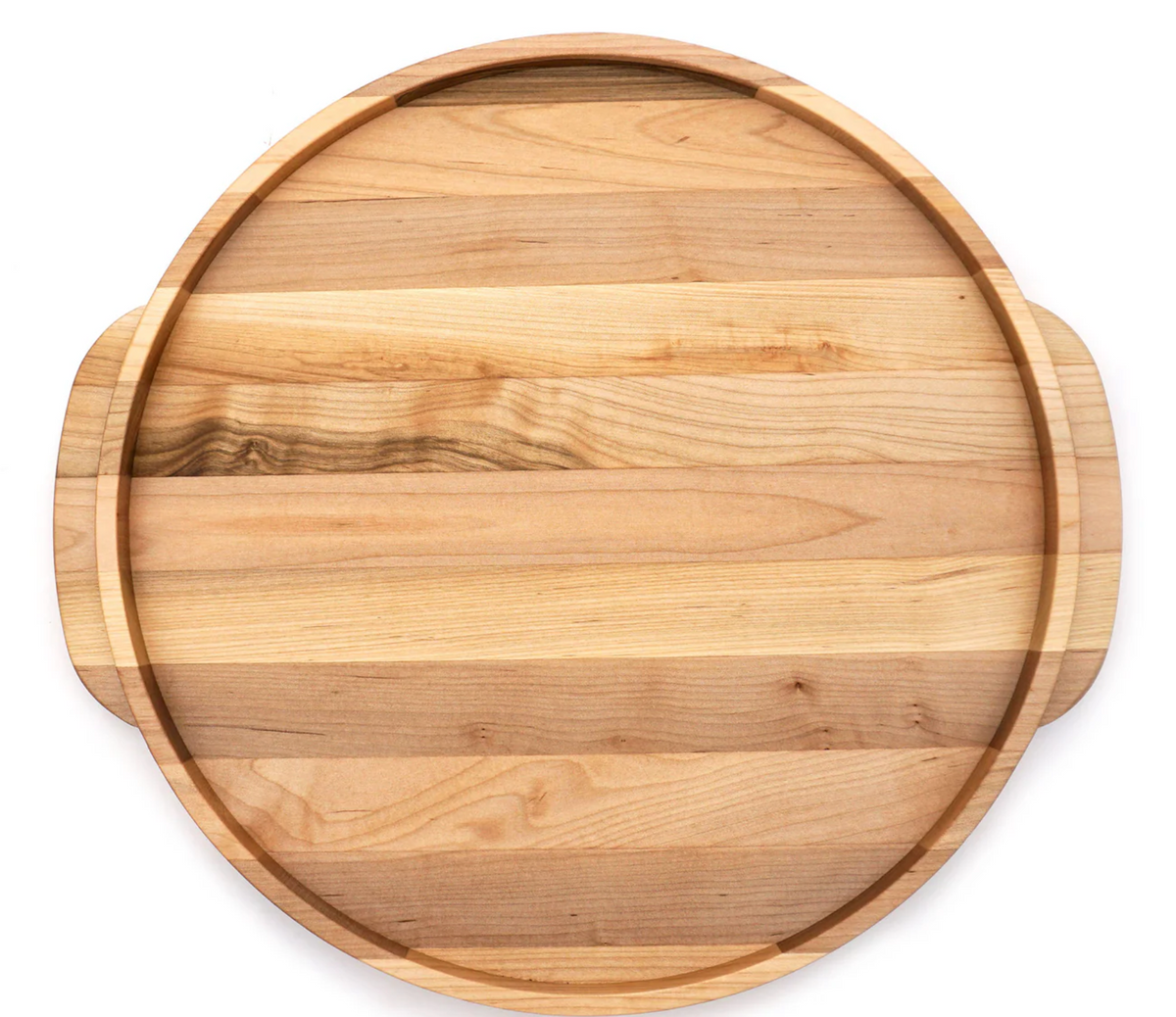 The JK Adams Elmore Round Serving Board features natural wood grain, a grooved edge, and two small side handles. Shown from above on a white background.