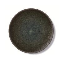 The Tourron Samoa round artisan stoneware plate by Jars - Rosenthal, featuring dark gray speckles, casts a subtle shadow against a white background.