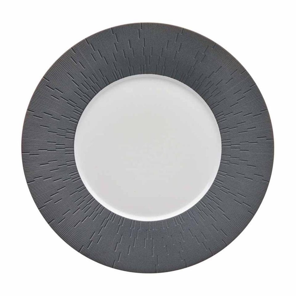 The Anthracite Infini Dinnerware Grey by Haviland is a round white plate with a wide, textured dark gray rim featuring radiating lines and a smooth, plain Limoges porcelain center.