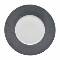 The Anthracite Infini Dinnerware Grey by Haviland is a round white plate with a wide, textured dark gray rim featuring radiating lines and a smooth, plain Limoges porcelain center.