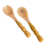 pair of resin salad servers on white backgroun d