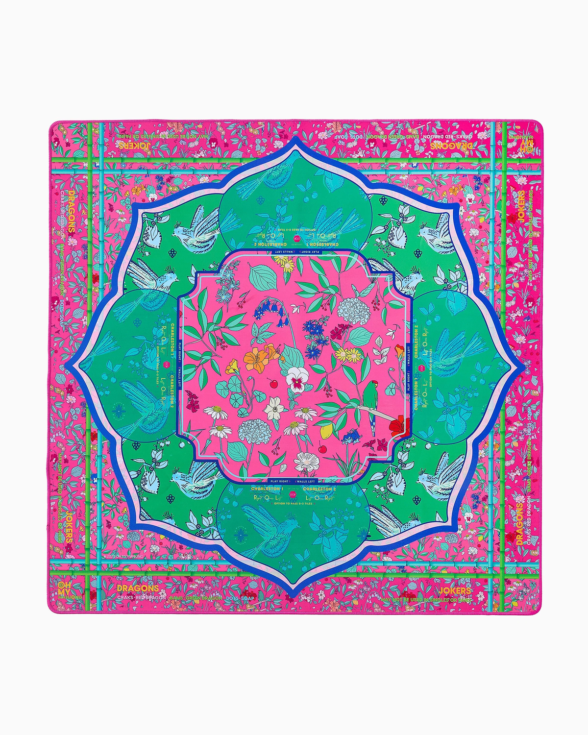 Oh My Mahjong’s Mahjong Mats square scarf features a vibrant pink, green, and blue design inspired by Mahjong mats, with birds, flowers, leaves, and ornate borders arranged in a symmetrical pattern.