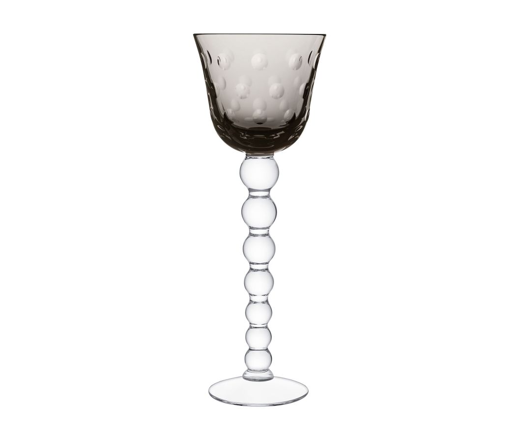 The Saint-Louis Bubbles Hock Stemware features a translucent smoky gray bowl with raised dots and a clear stem of stacked glass spheres, ending in a flat base—ideal for crystal table settings or pairing with contemporary Saint-Louis designs.