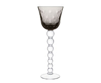 The Saint-Louis Bubbles Hock Stemware features a translucent smoky gray bowl with raised dots and a clear stem of stacked glass spheres, ending in a flat base—ideal for crystal table settings or pairing with contemporary Saint-Louis designs.
