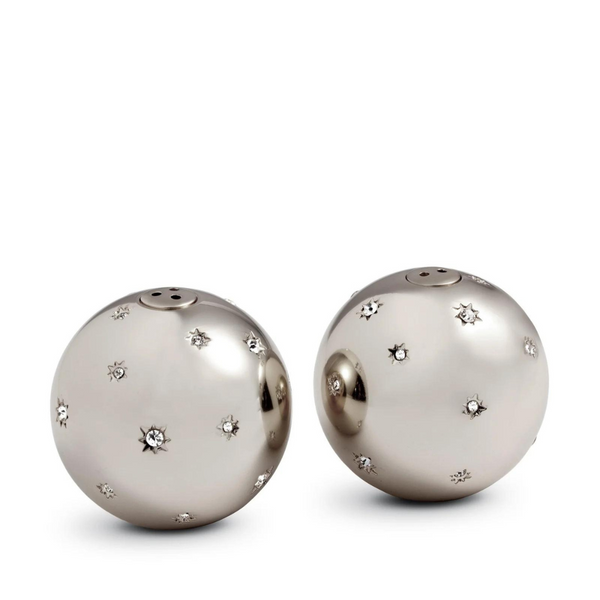 The L'Objet Stars Spice Jewels Salt & Pepper Set - Platinum features two round, metallic shakers with a shiny finish and small star motifs, some accented with sparkling Swarovski crystals, arranged side by side on a plain white background.