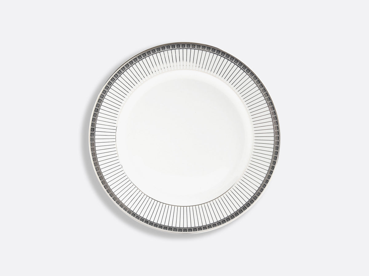 A white porcelain plate from Bernardaud's Athena Platinum Dinnerware Collection features a platinum-toned geometric rim and is displayed against a plain light gray background.