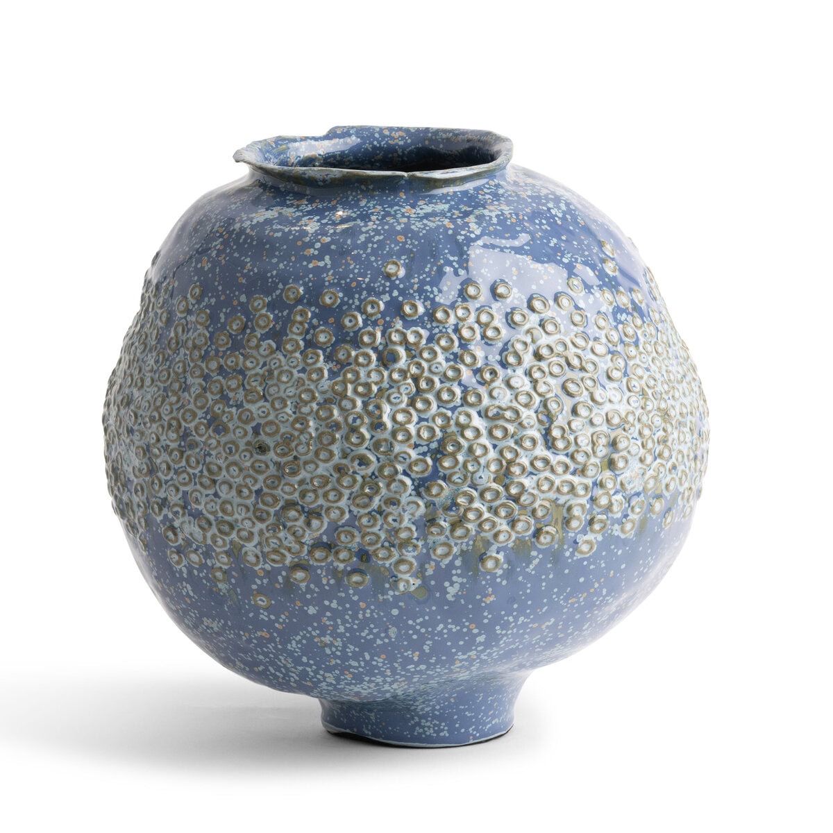 The Ashley Vase - Blue by FlowDecor Inc. is a round ceramic vase with a narrow opening and a textured surface that showcases raised circular patterns accented with white speckles. This eye-catching decorative piece is photographed against a plain white background.