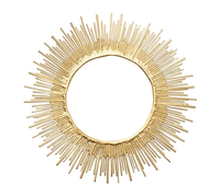 Inspired by Kim Seybert's Radiate Charger in Gold Set of 4, this round decorative mirror features a sunburst design with gold rods of varying lengths forming a striking circular pattern against a white backdrop.