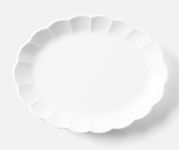 The Blue Pheasant Iris Melamine Dinnerware Oval Serving Platter 16" features a glossy white finish with scalloped edges, displayed empty on a light, neutral background.